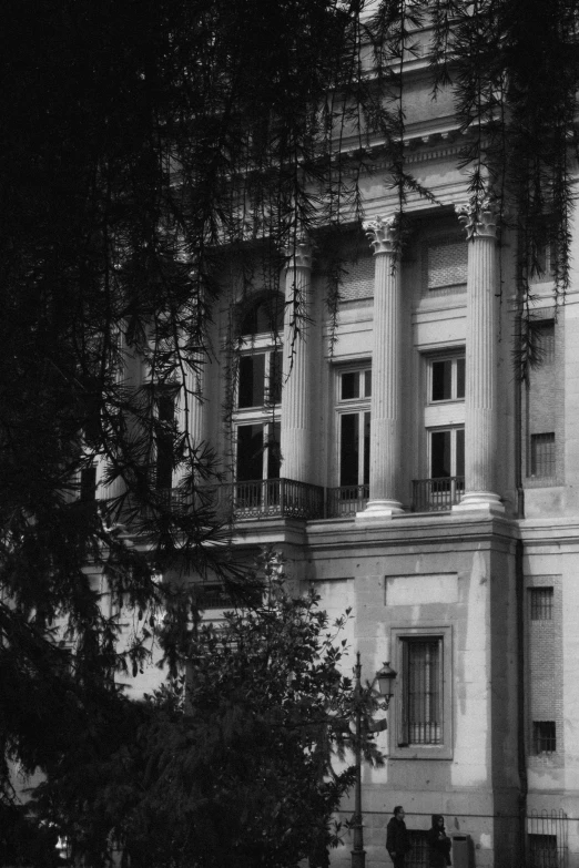 an old building that has trees in front of it