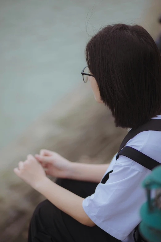 the young person is wearing glasses and holding soing