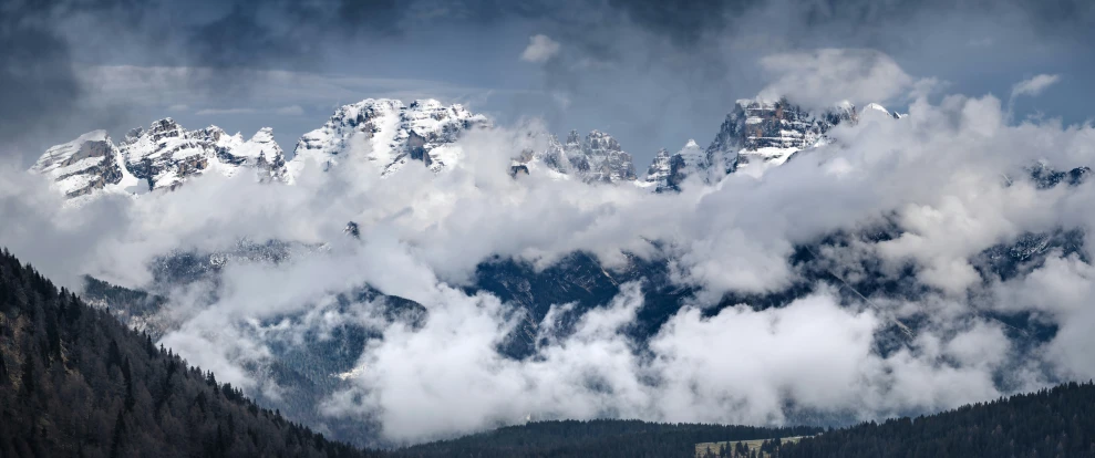 some mountain tops are covered in low cloud