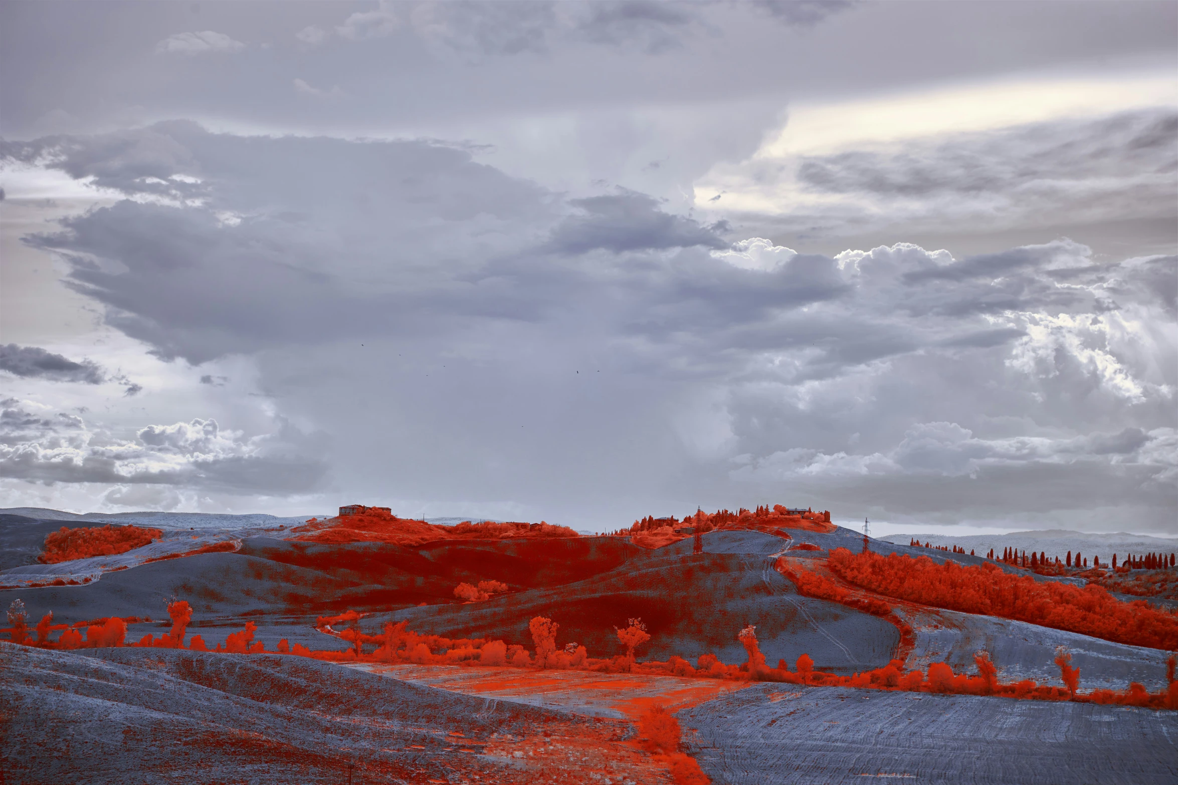 an infrared landscape of a mountain scene with trees and clouds