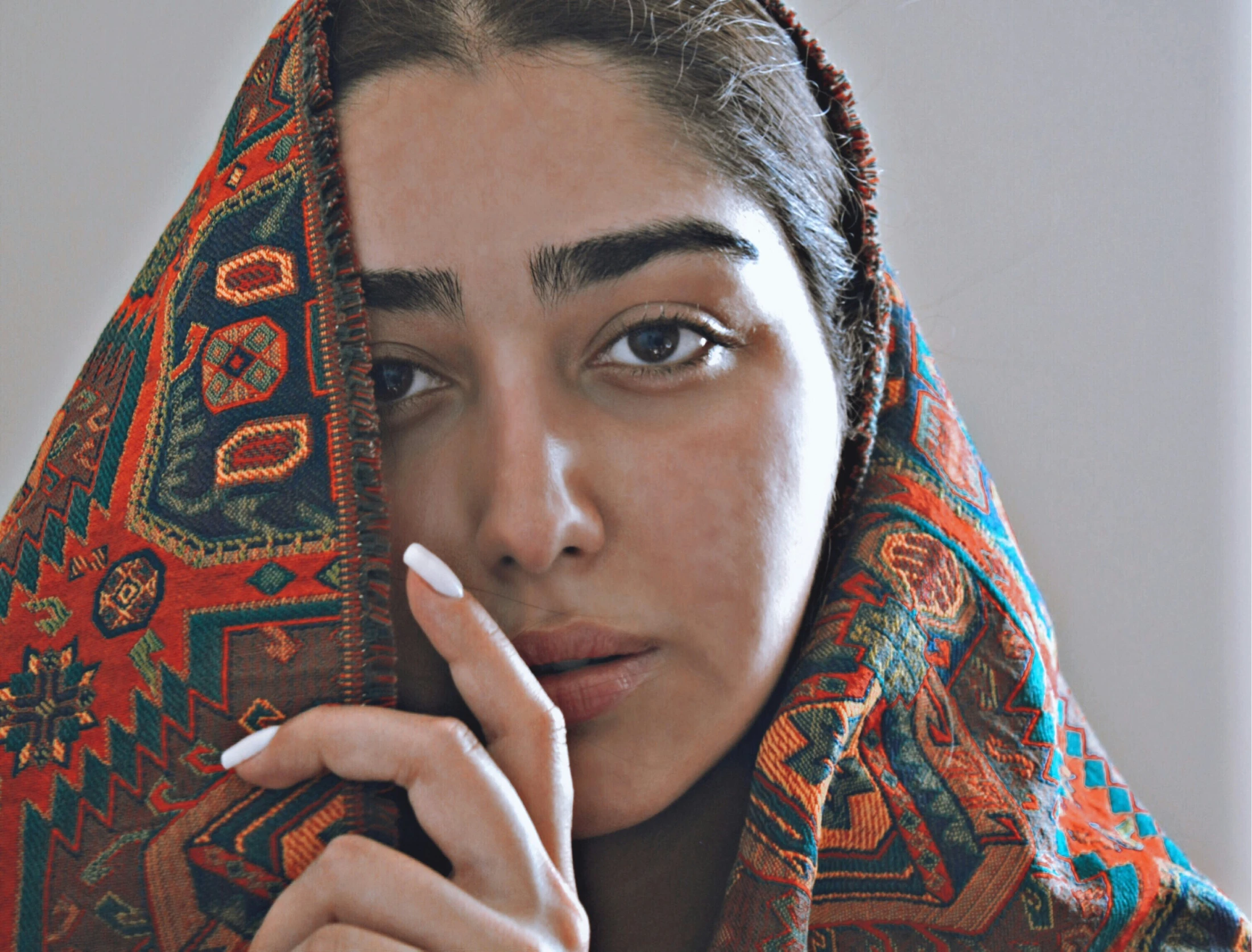 a close - up of a woman wearing a cloth on her head