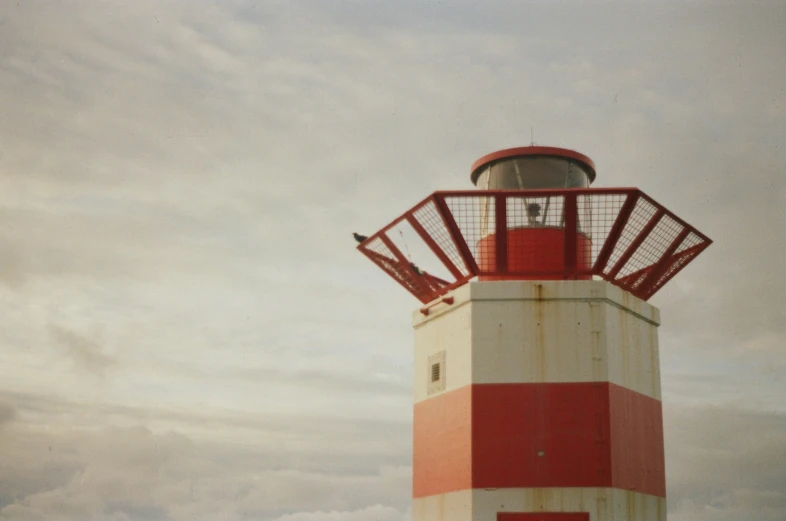 a big tower with a red and white top