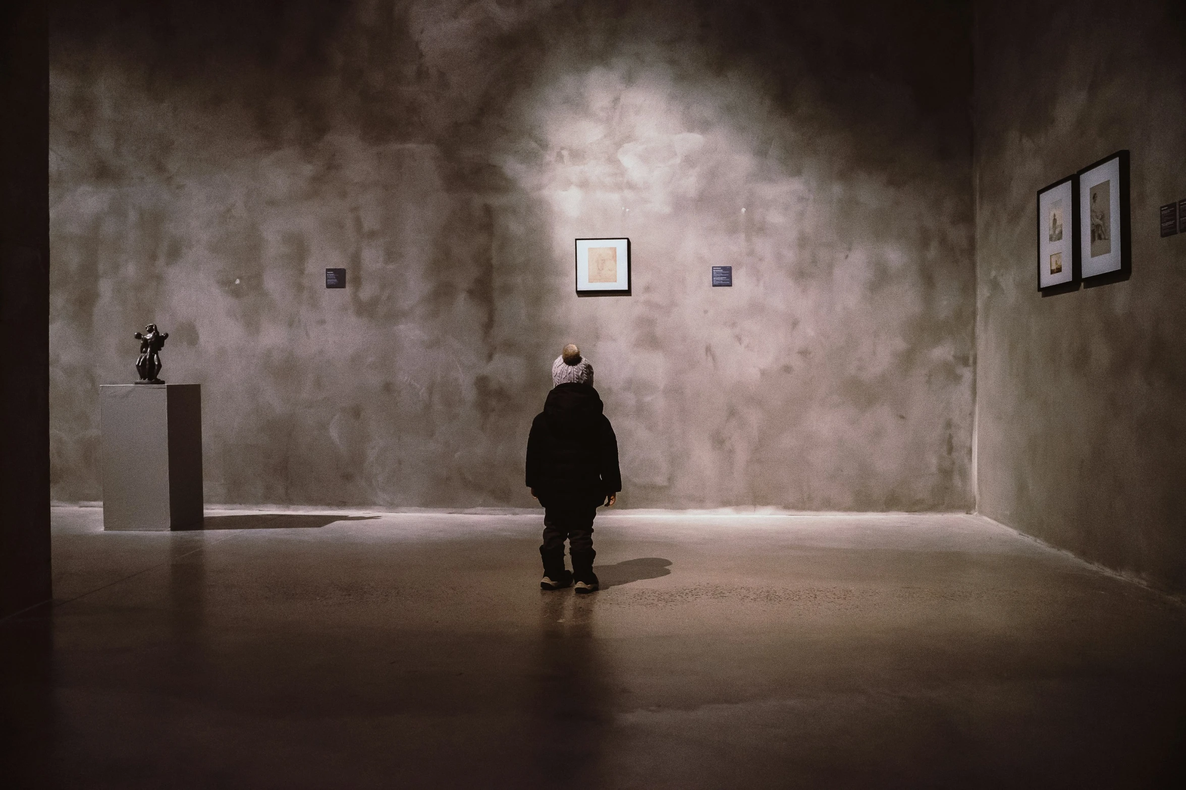 a woman in a black jacket and some picture frames