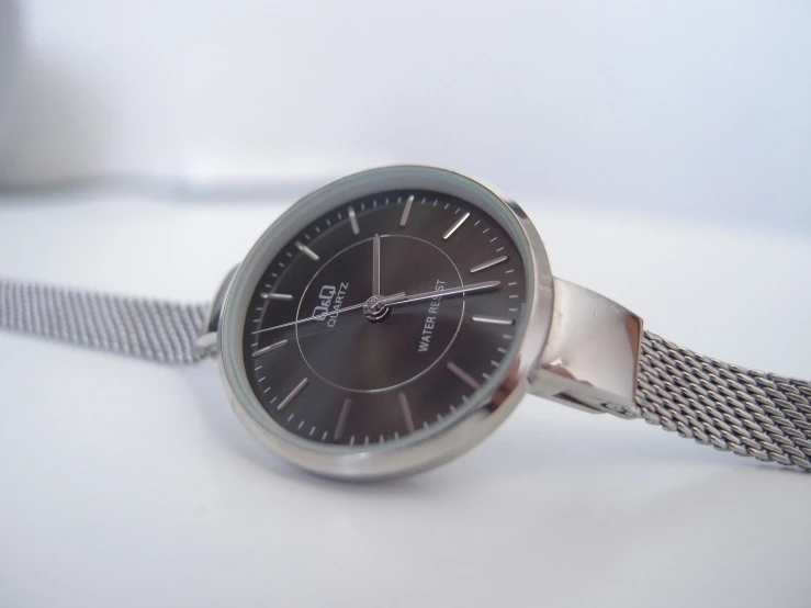 a watch that is sitting on a white table