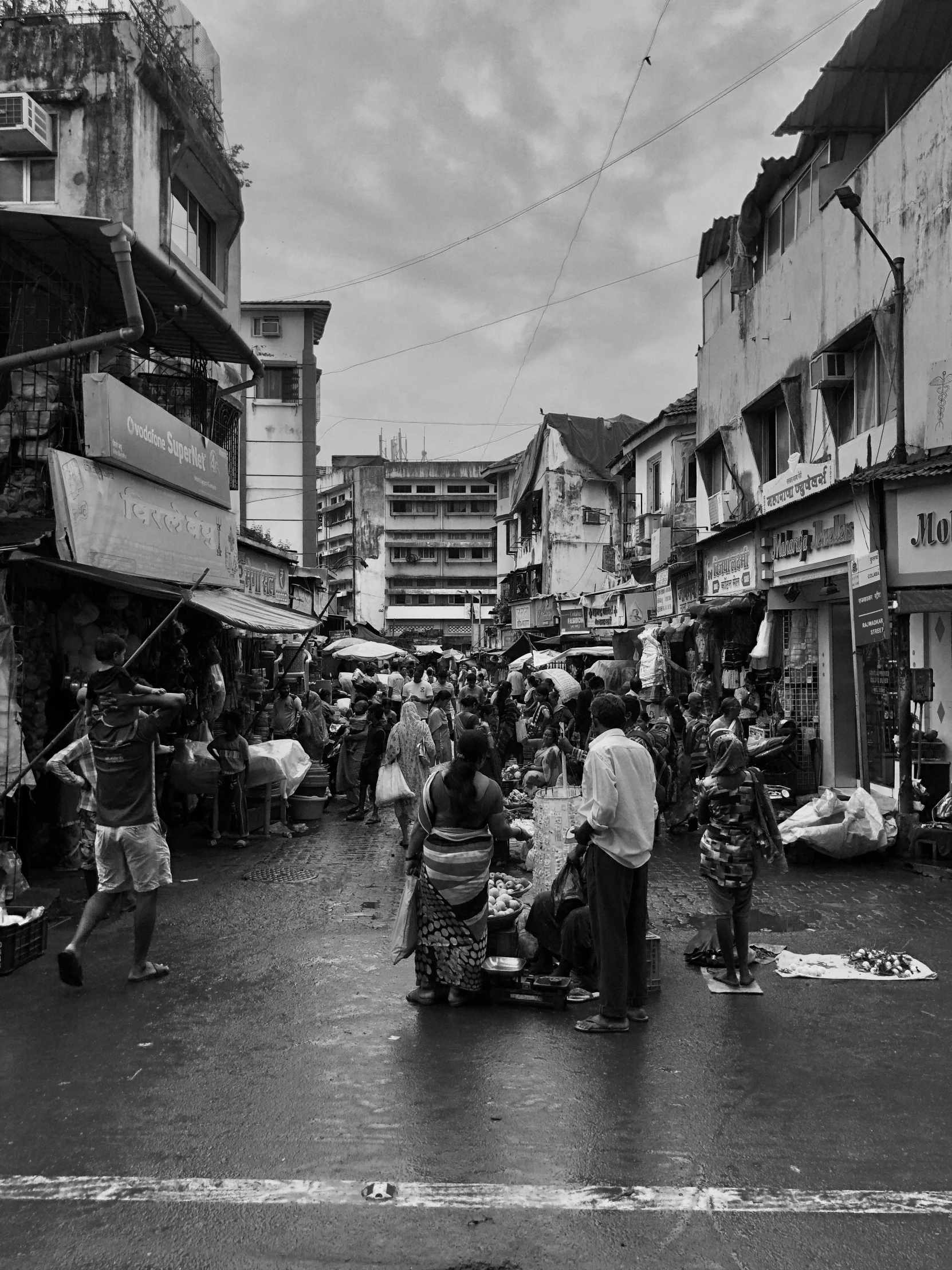 a market place with pedestrians and vendors