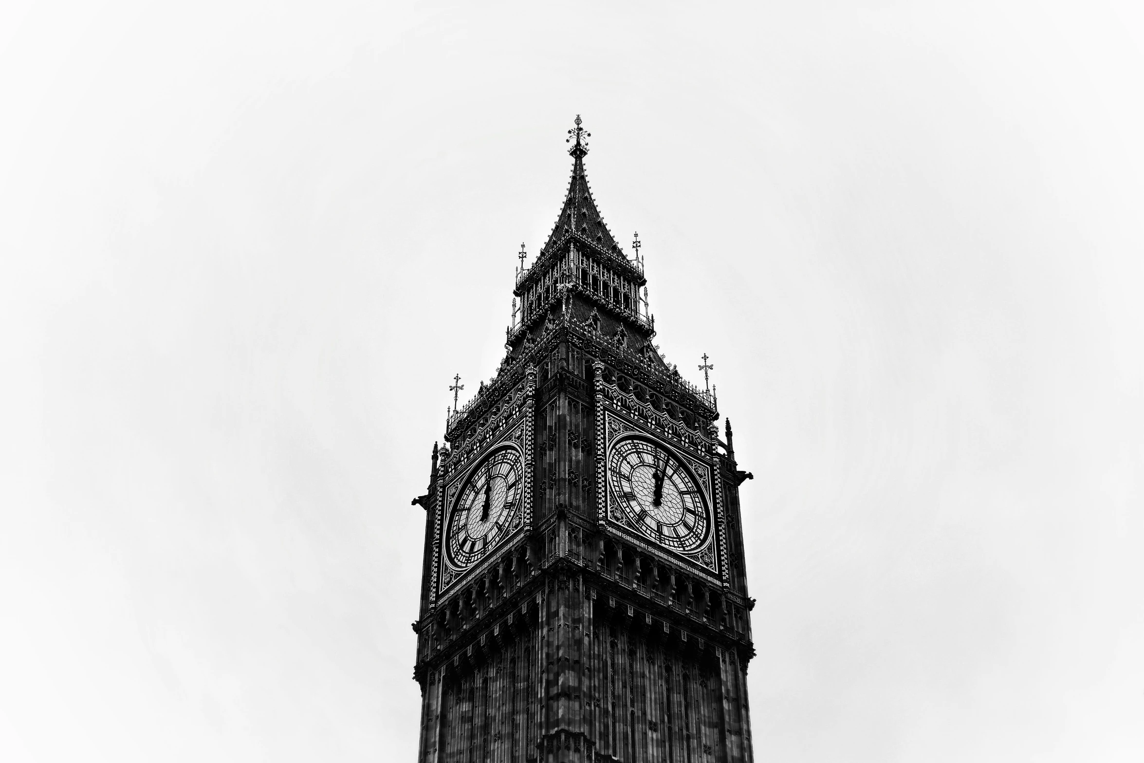 a large black clock tower in a big city