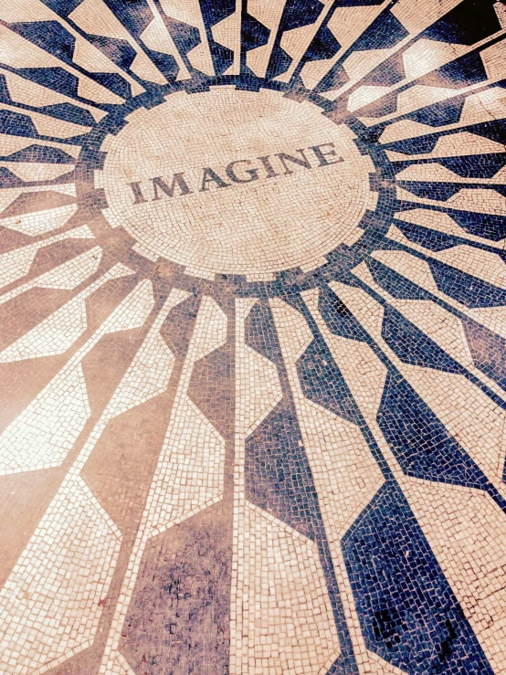 an artistic mosaic of a building with an imagine written on it