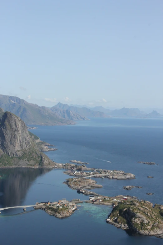 a large lake filled with lots of water next to mountain side