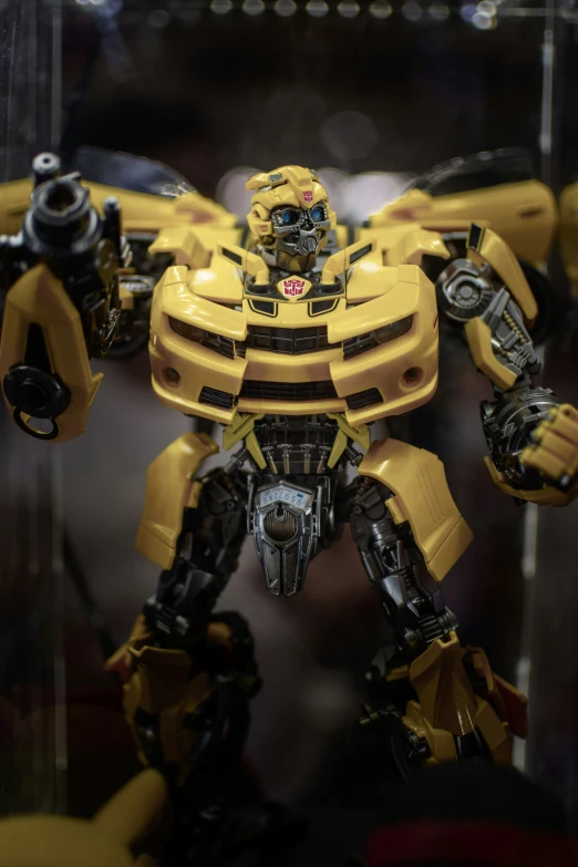 a yellow and black robot in the window