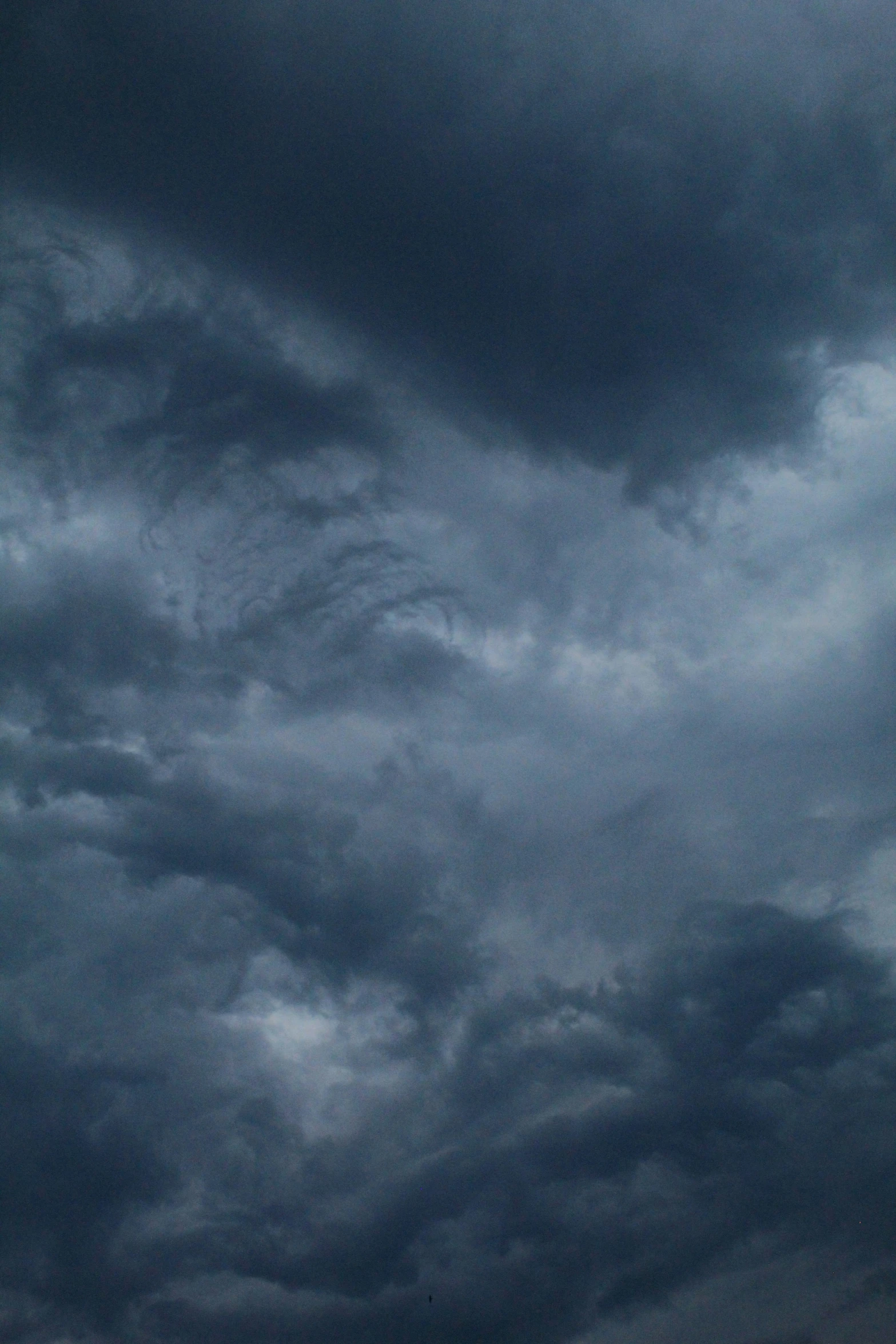 a dark cloudy sky with two planes in it