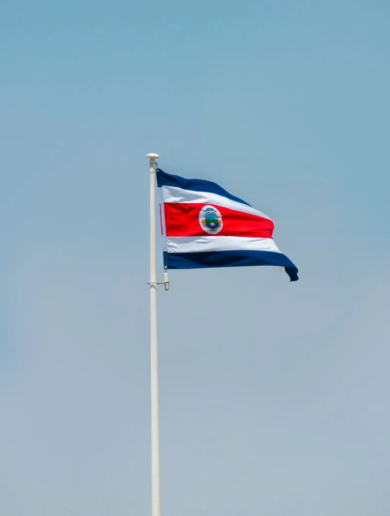 a flag is flying in the wind on a cloudy day