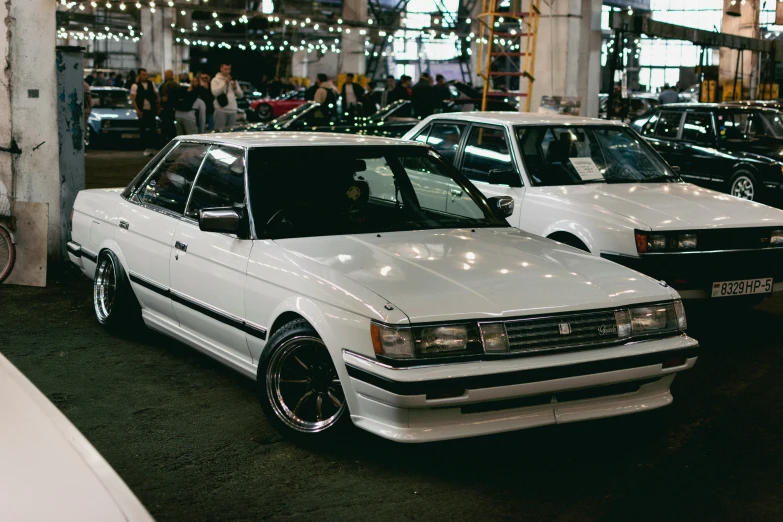 two white cars parked next to each other