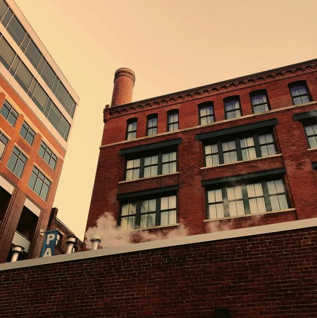 a brick building is shown with smoke pouring out of the windows