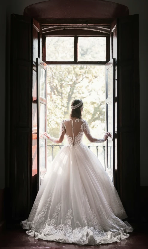 bride in front of the door of the wedding gown