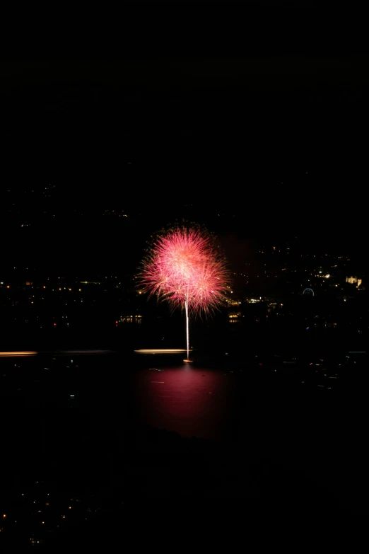 a fireworks display in the sky over the water