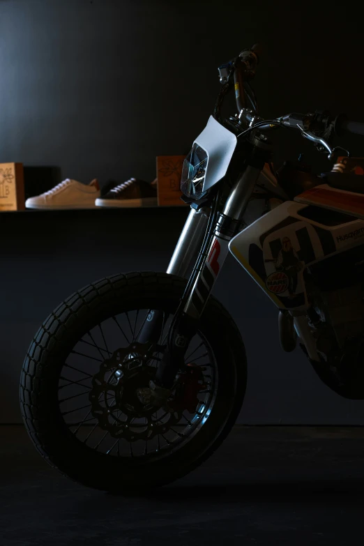 a motorcycle parked in front of a dark wall