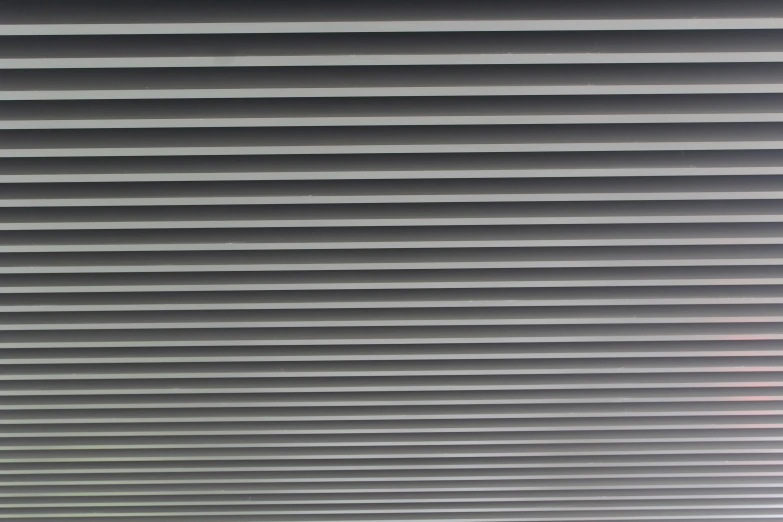 many horizontal blinds are closed at the top of the window