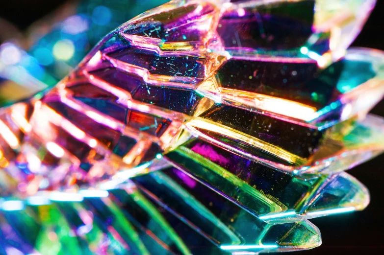 some very colorful glass object sitting on top of a black table