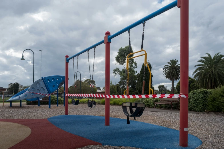 a playground that has a red, white, and blue slide next to it