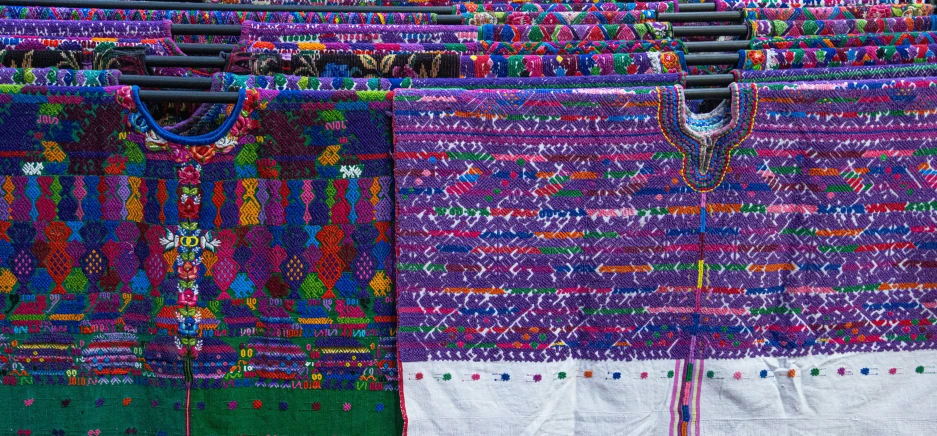 several knits on a clothesline hanging in front of a mirror