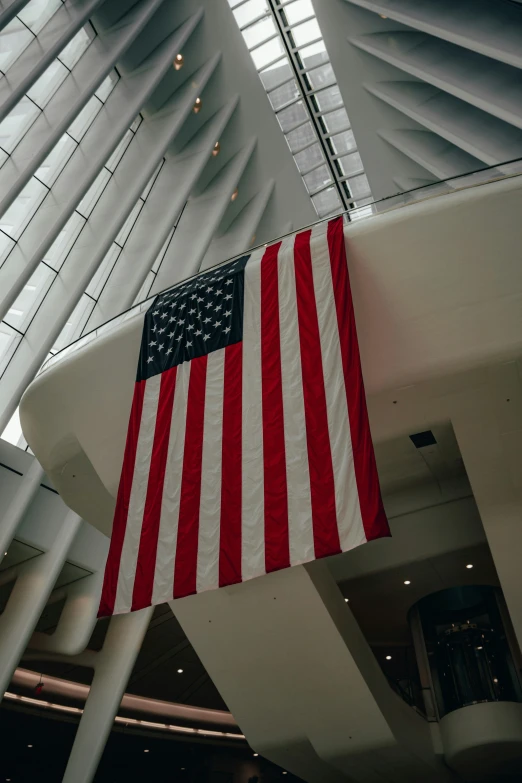 a large american flag on display inside a building