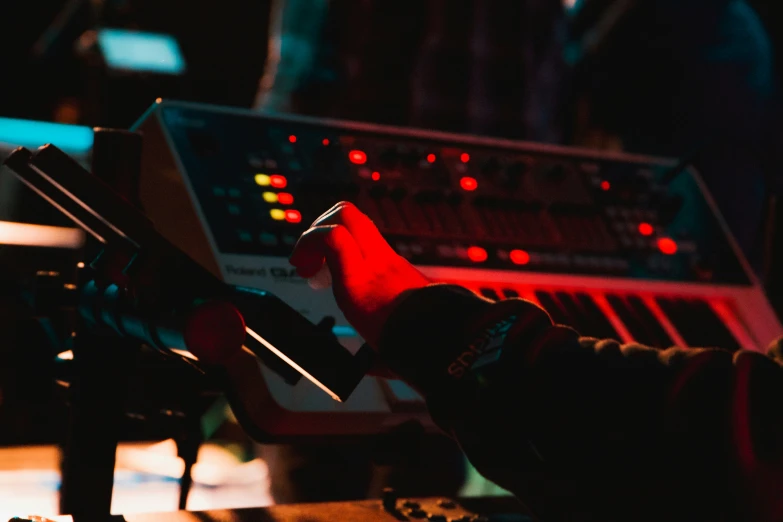 a person with their hand near some equipment