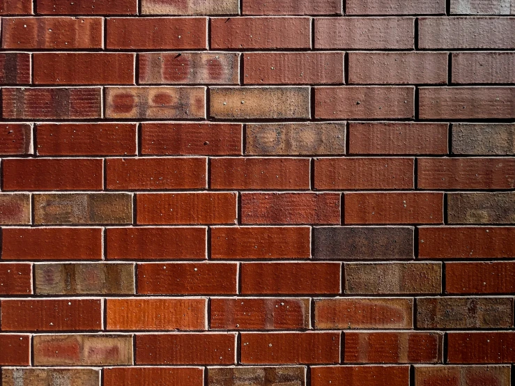 a wall made up of old bricks with faded paint