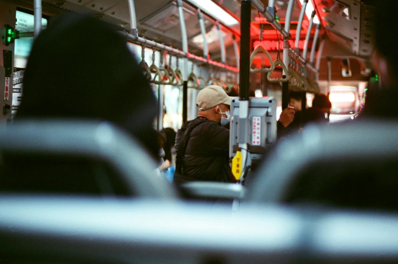 a public transit bus with passengers on the side