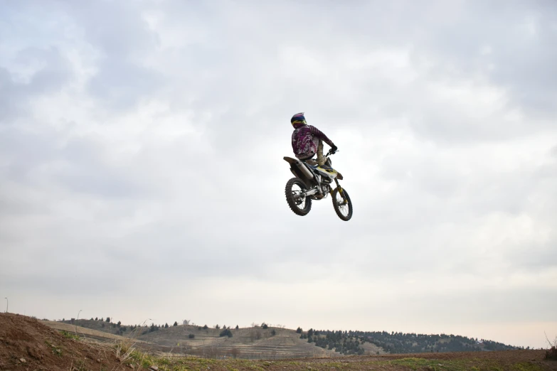 a person on a motorcycle jumping high in the air