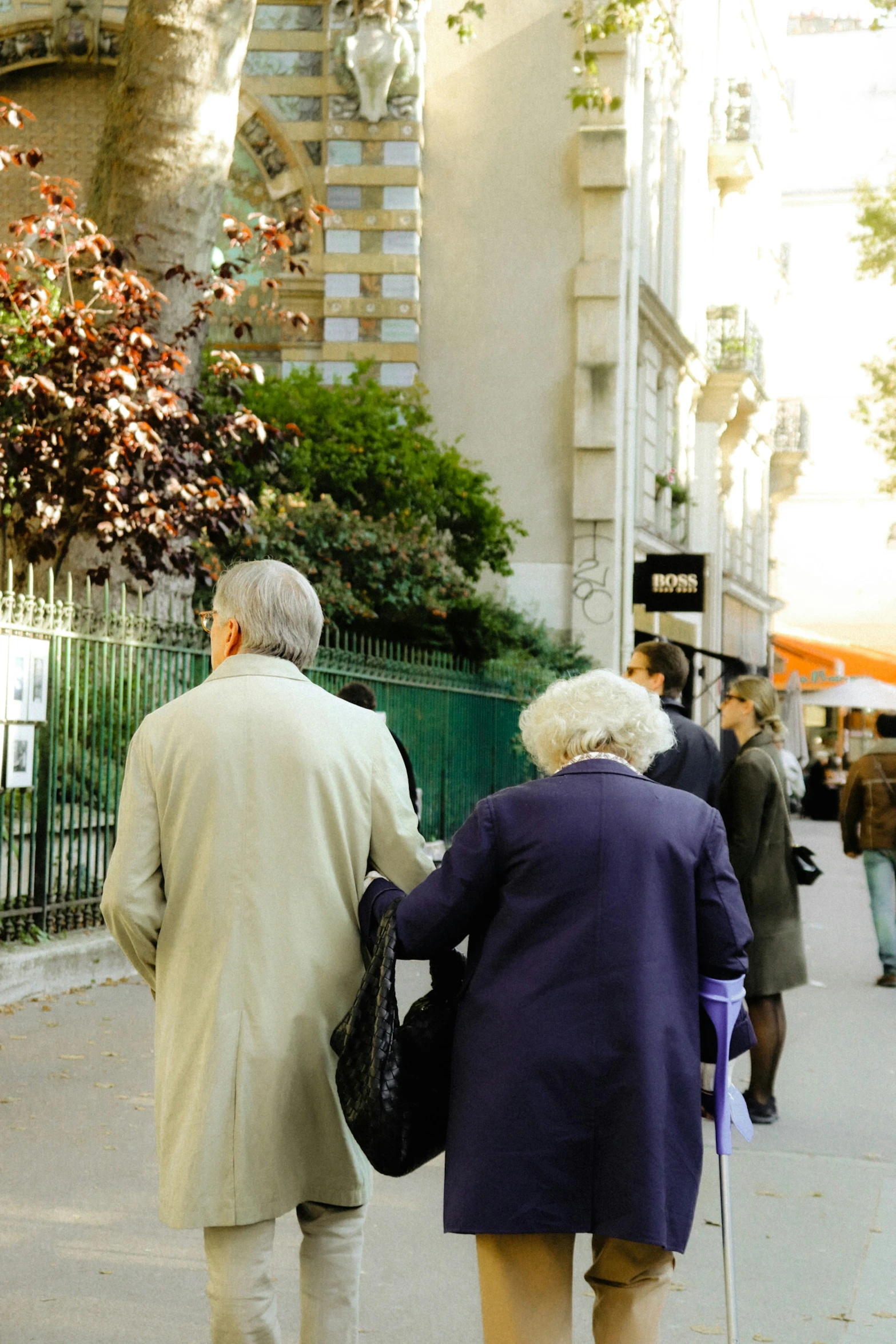 a couple of elderly people walking down the street