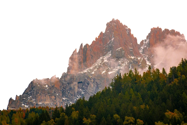 tall mountains are surrounded by many green trees