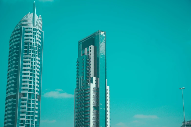 three high rise buildings and a street light near the end of a highway