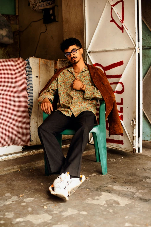 a man sitting on a bench with his foot on a skateboard