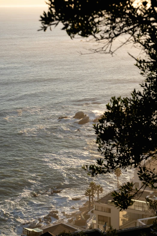 a large body of water with a cliff in the background