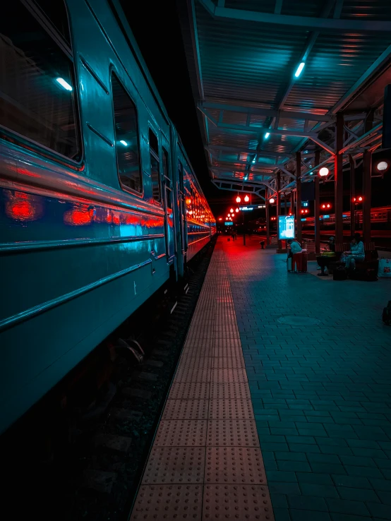 night scene at train station with red lights on