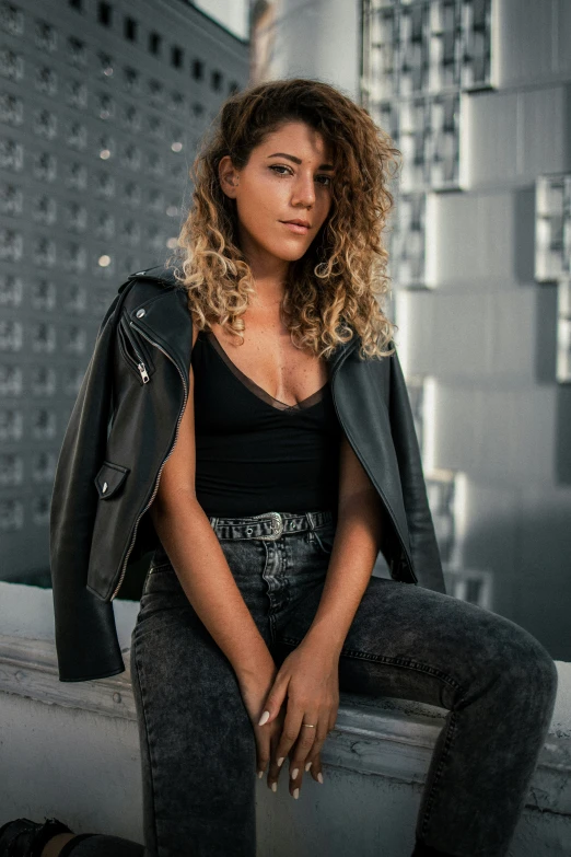 a woman is sitting and posing for a po