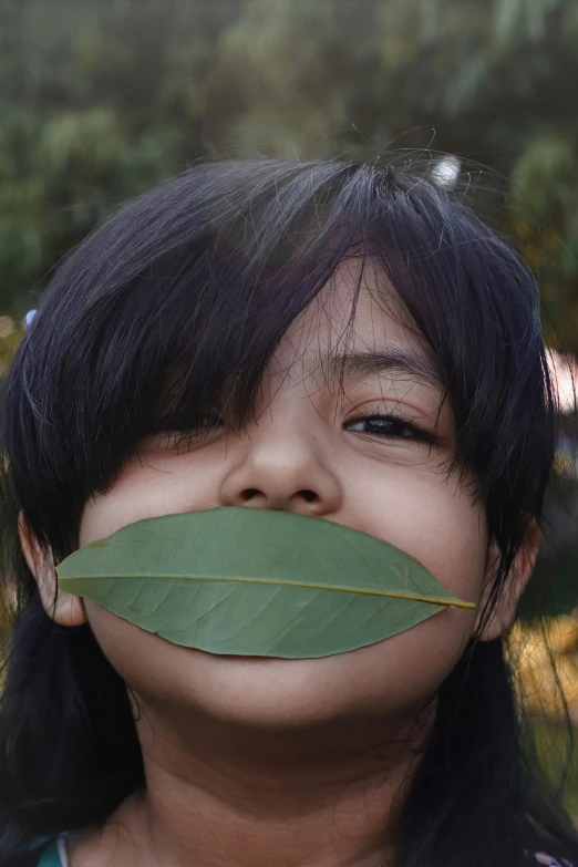 a  is wearing a fake moustache on her face