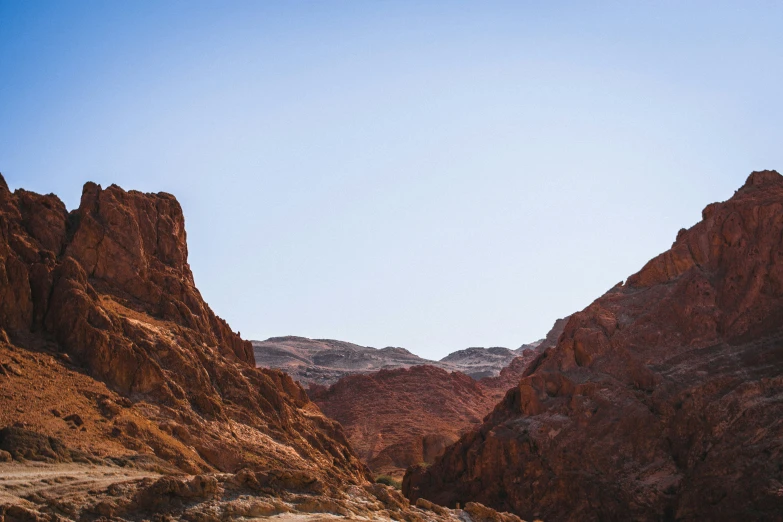 a desert landscape with mountains, dirt and plants