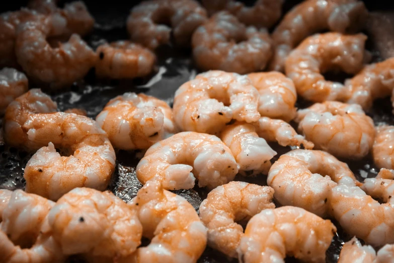 fried shrimp being cooked in a frying pan