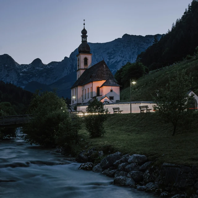 a church in the mountains lit up at night