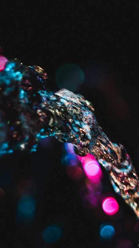 a close up of some colorful lights and water