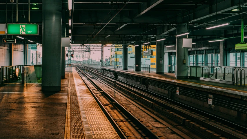 a train station with rows of rails and an empty platform