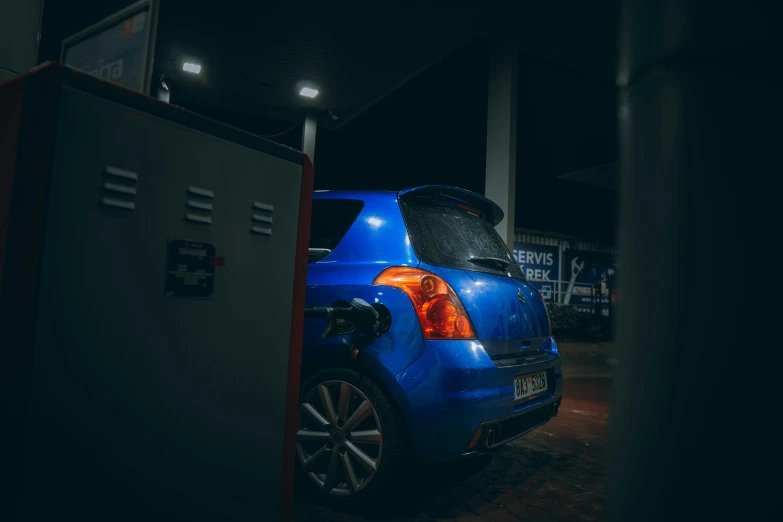 a blue small car parked in a parking space