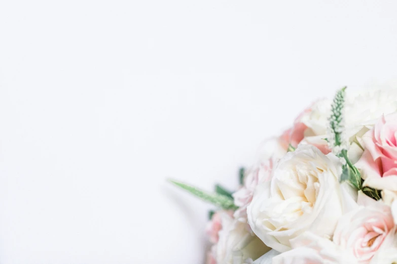 a bridal bouquet of white and pink roses