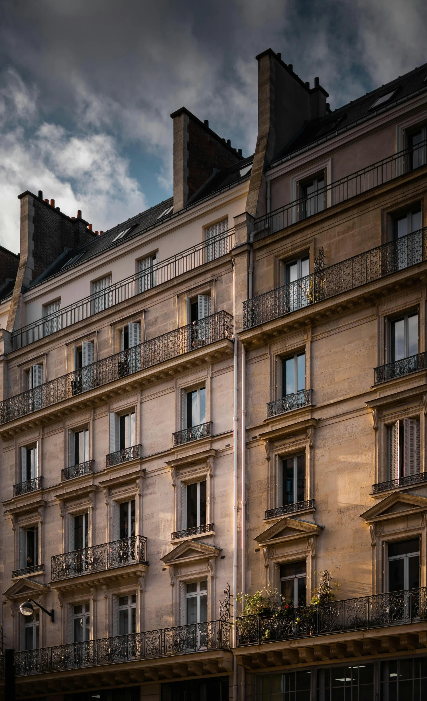 an old apartment building with a clock on the front