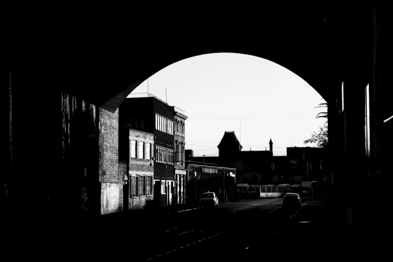 an archway leading into the dark side of town