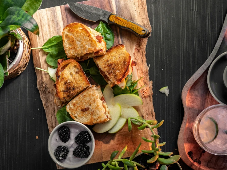 a sandwich cut into four pieces on top of a  board