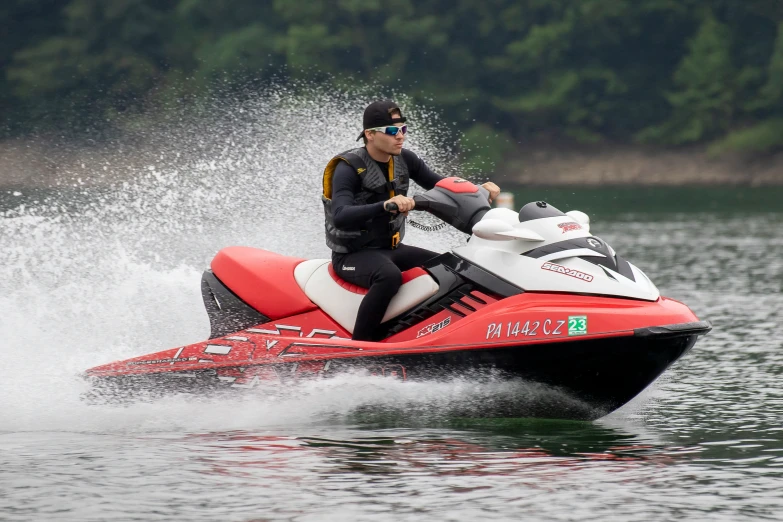 a man rides a jet ski on a lake