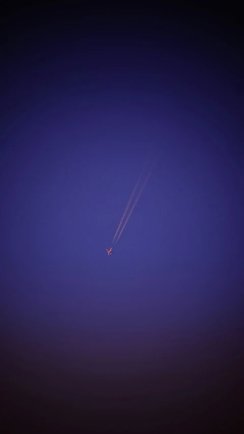 an airplane flying in a blue sky over another plane