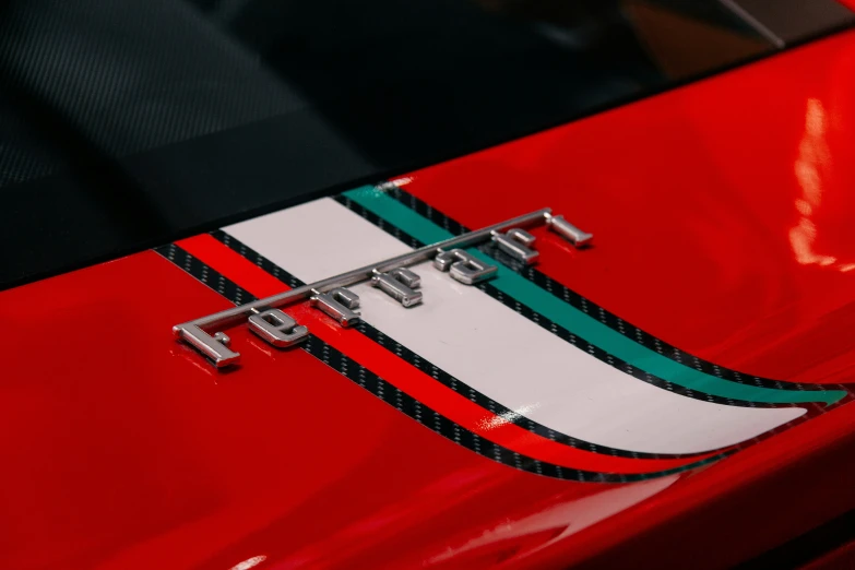 red sports car emblem with green and black stripeing
